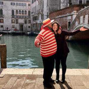 people posing next to canal